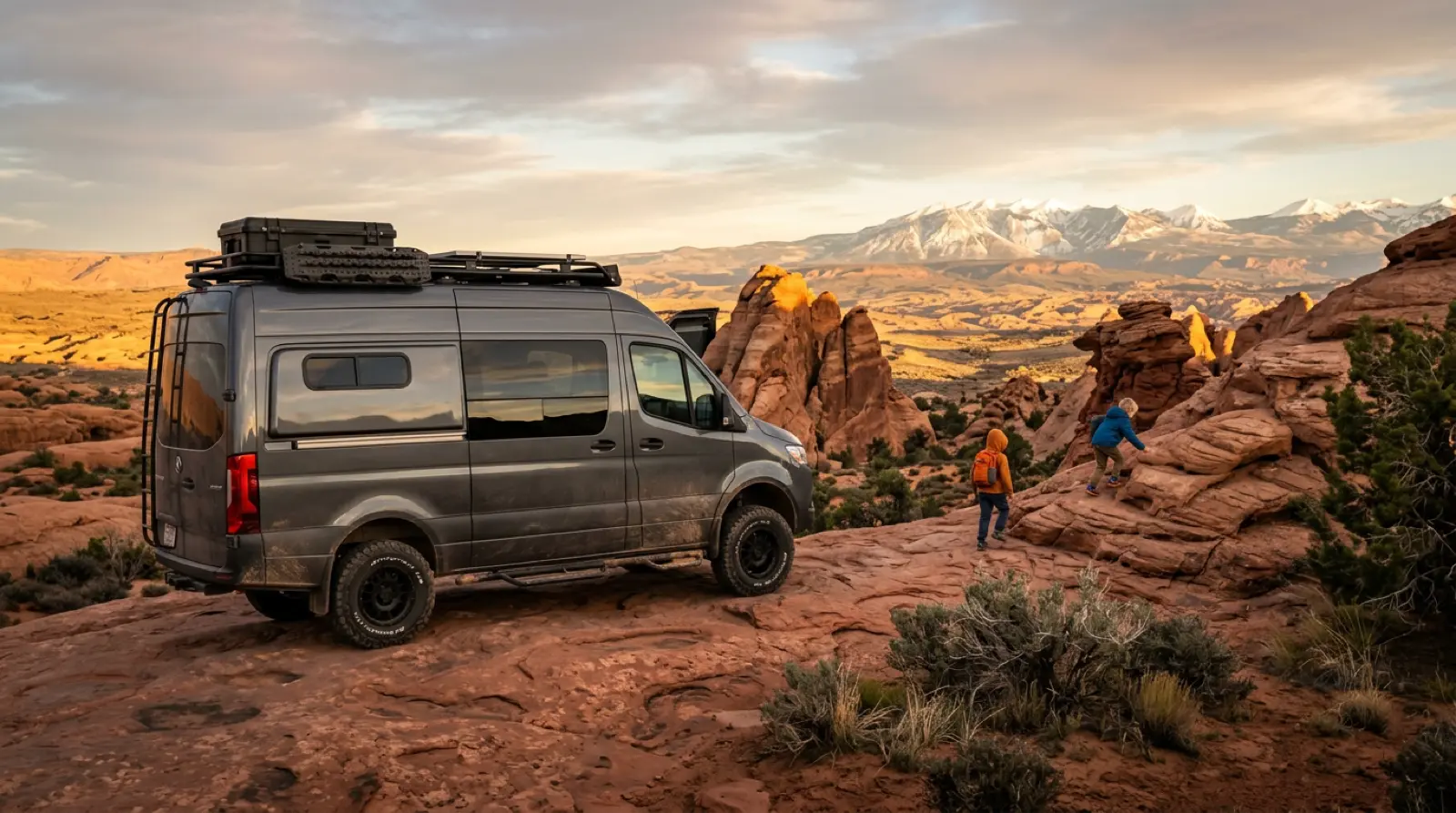 Family off-road rig climbing red sandstone slickrock near Moab