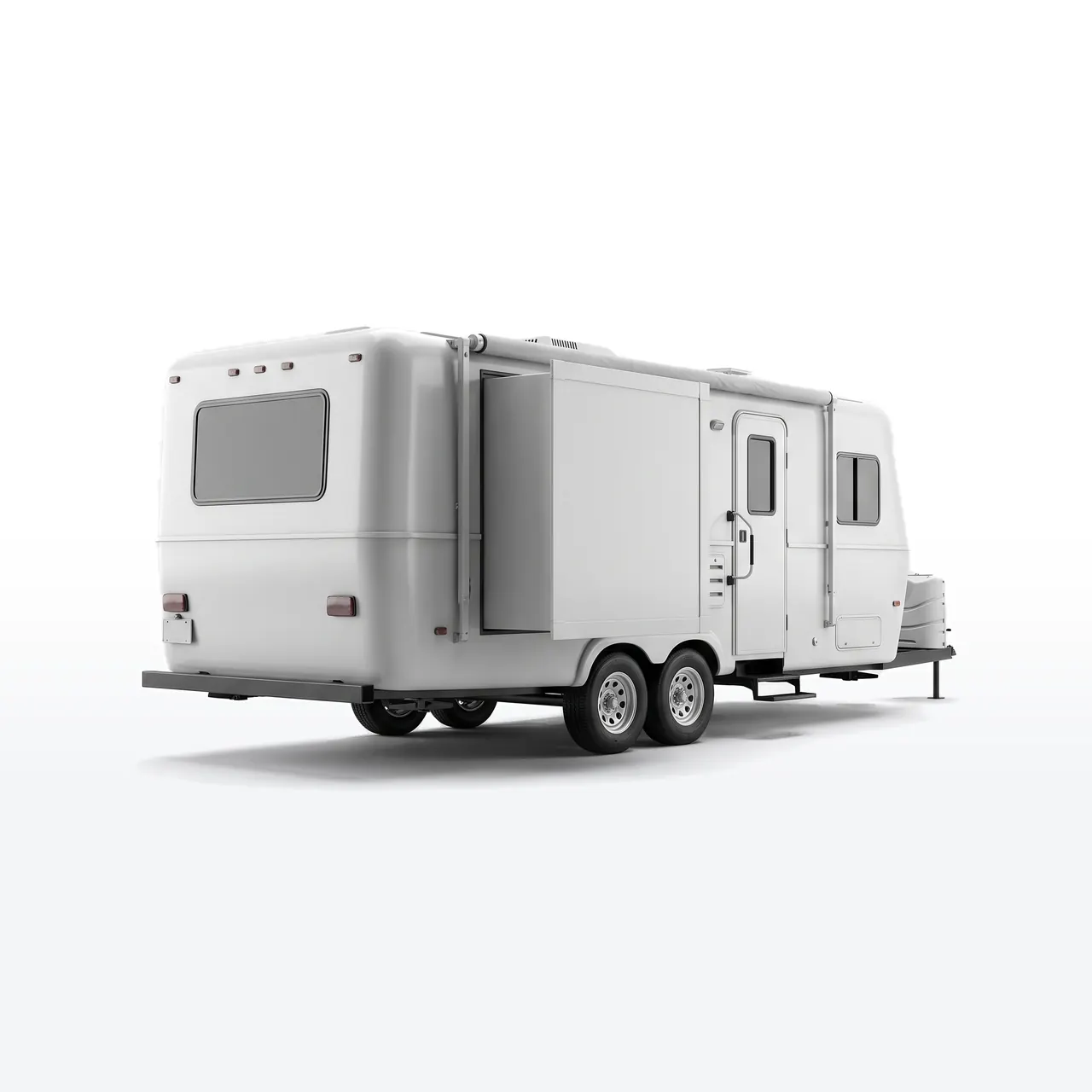 A plain white travel trailer on a studio floor
