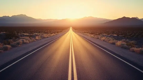 Empty Nevada desert highway stretching to distant mountains